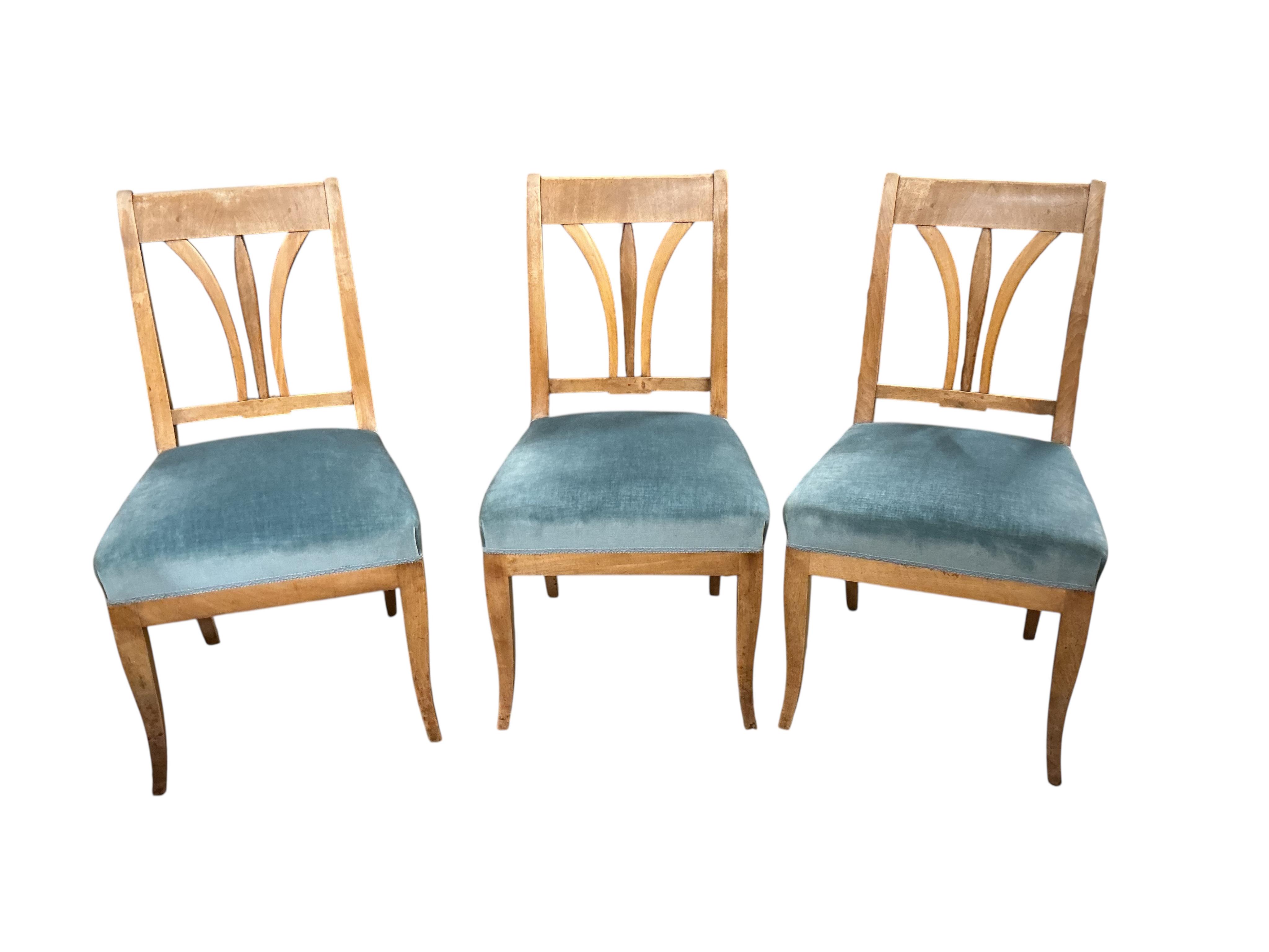 A Swedish circular walnut breakfast table, diameter 107cm, height 76cm together with four dining chairs, one with arms